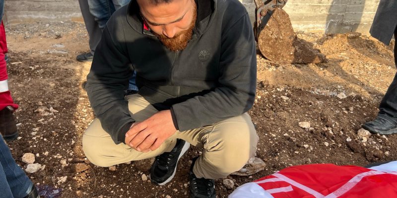 A-relative-bids-farewell-to-a-martyred-relative-before-burying-him-amidst-tight-Israeli-restrictions.jpeg