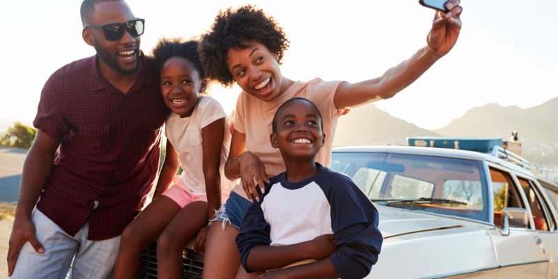 Family-road-trip-with-parents-taking-selfie-with-kids-scaled.jpg